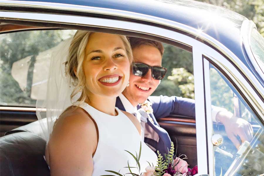 bride and groom in car