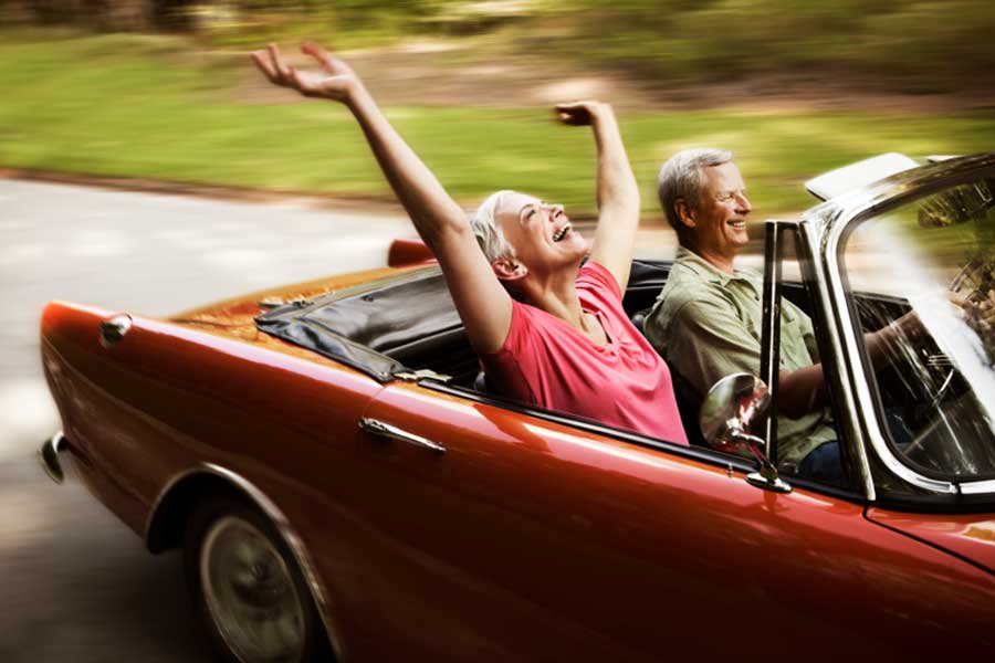 Senior Couple Driving a Convertible
