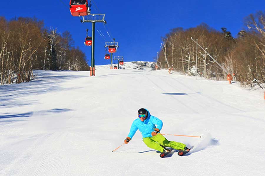 Man Downhill Skiing on a Sunny Day